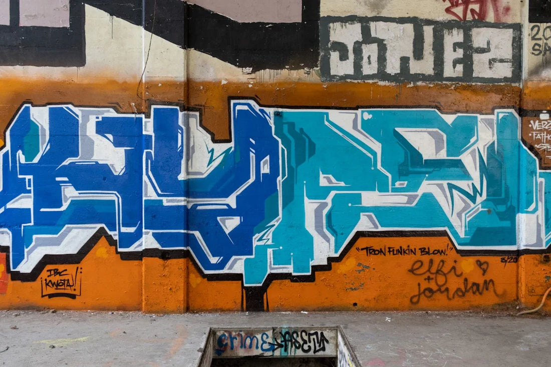 blue and yellow graffiti on wall