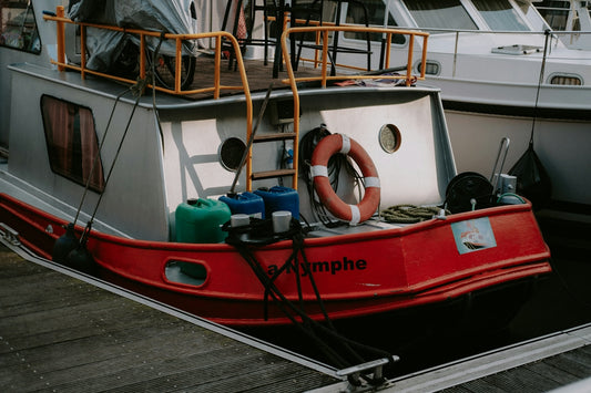 a red and white boat docked at a dock