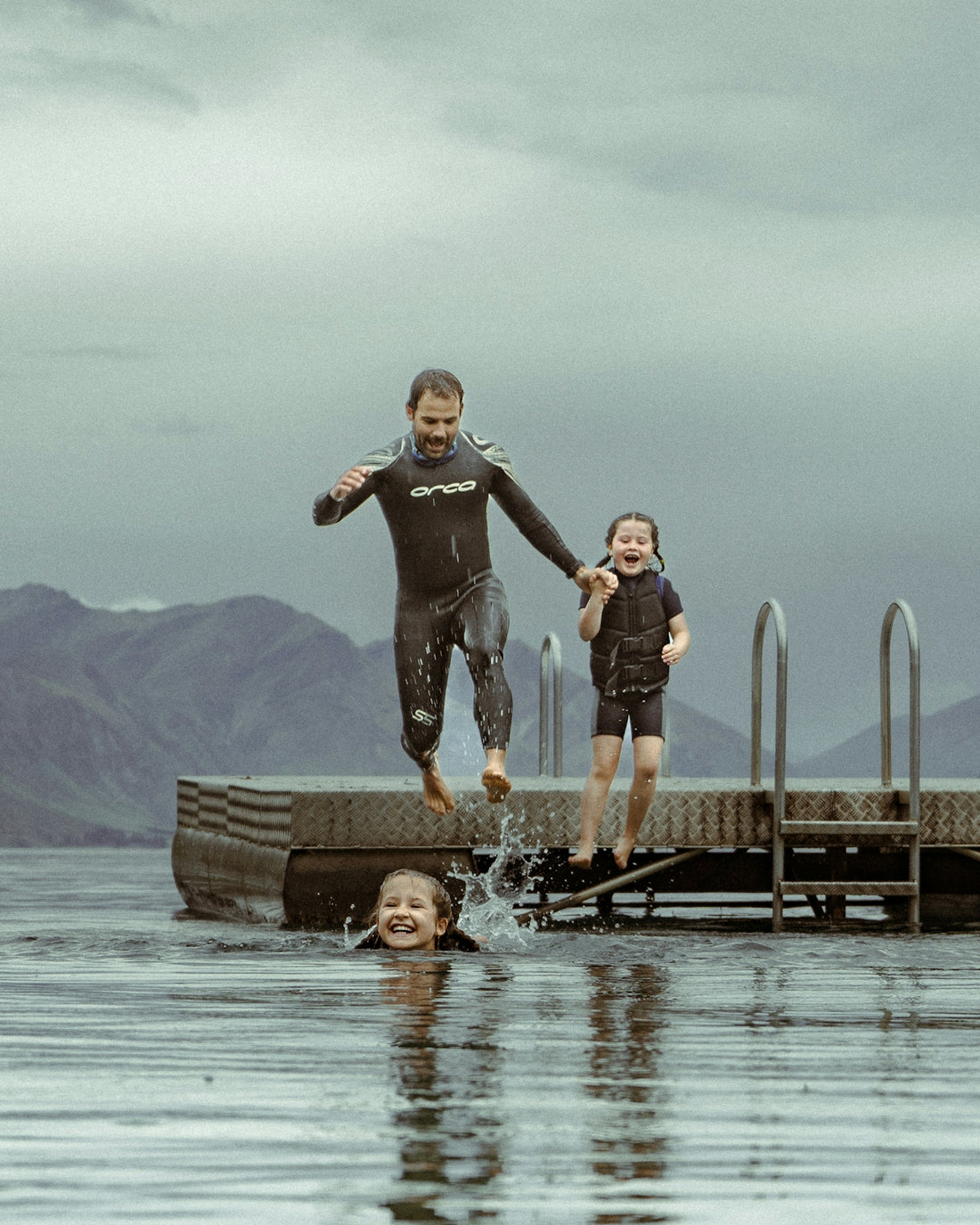 a man and a child jumping into water