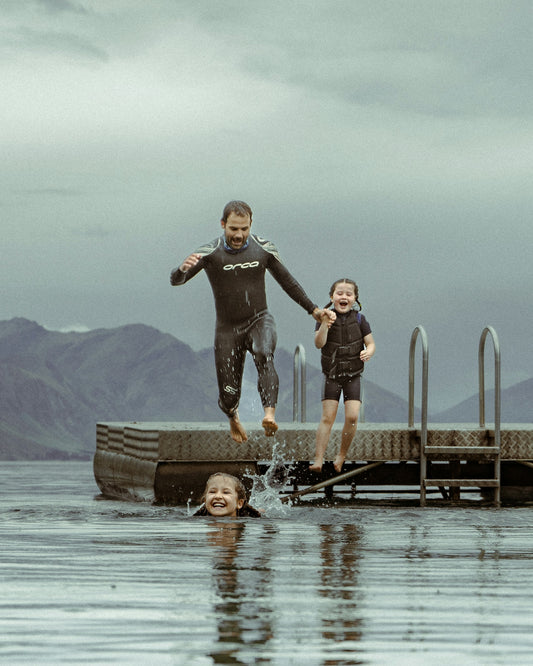 a man and a child jumping into water