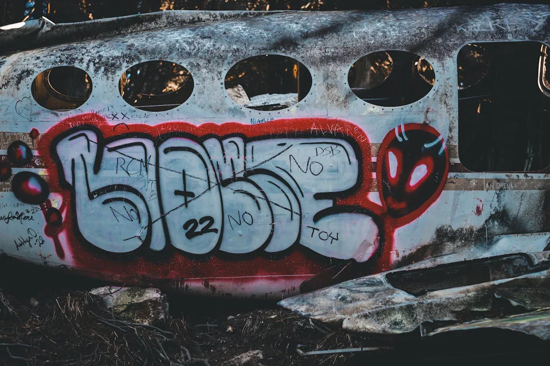 a rusted out airplane with graffiti on it