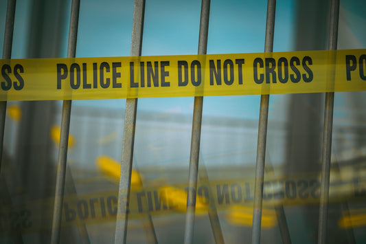 a close up of a yellow police line behind bars