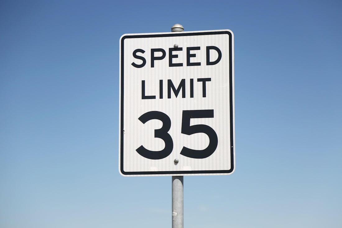 A speed limit sign on the side of the road