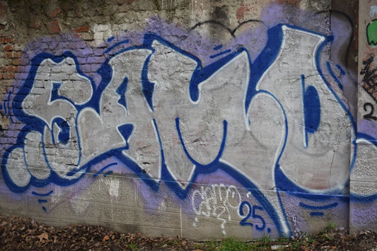 A wall with graffiti on it and a green fire hydrant